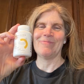 Jennifer T. from San Diego, CA holding a bottle of Joint Genesis – customer review