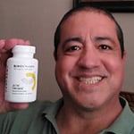 Michael S. from Austin, TX holding a bottle of Joint Genesis – customer review